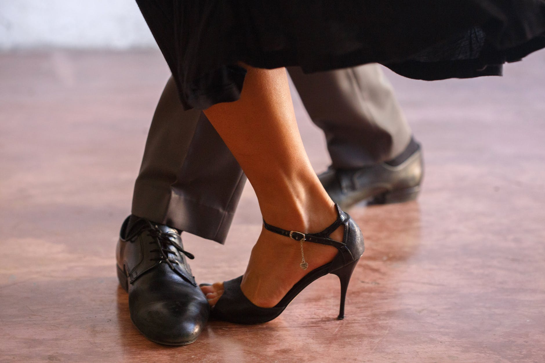 woman in black leather peep toe heeled shoes