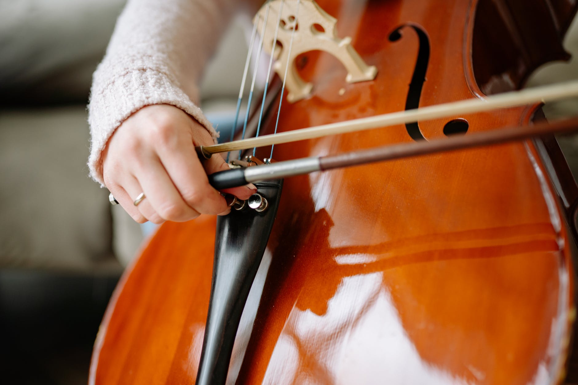 close up shot of a person playing a cello