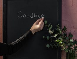 person writing on black board with chalk