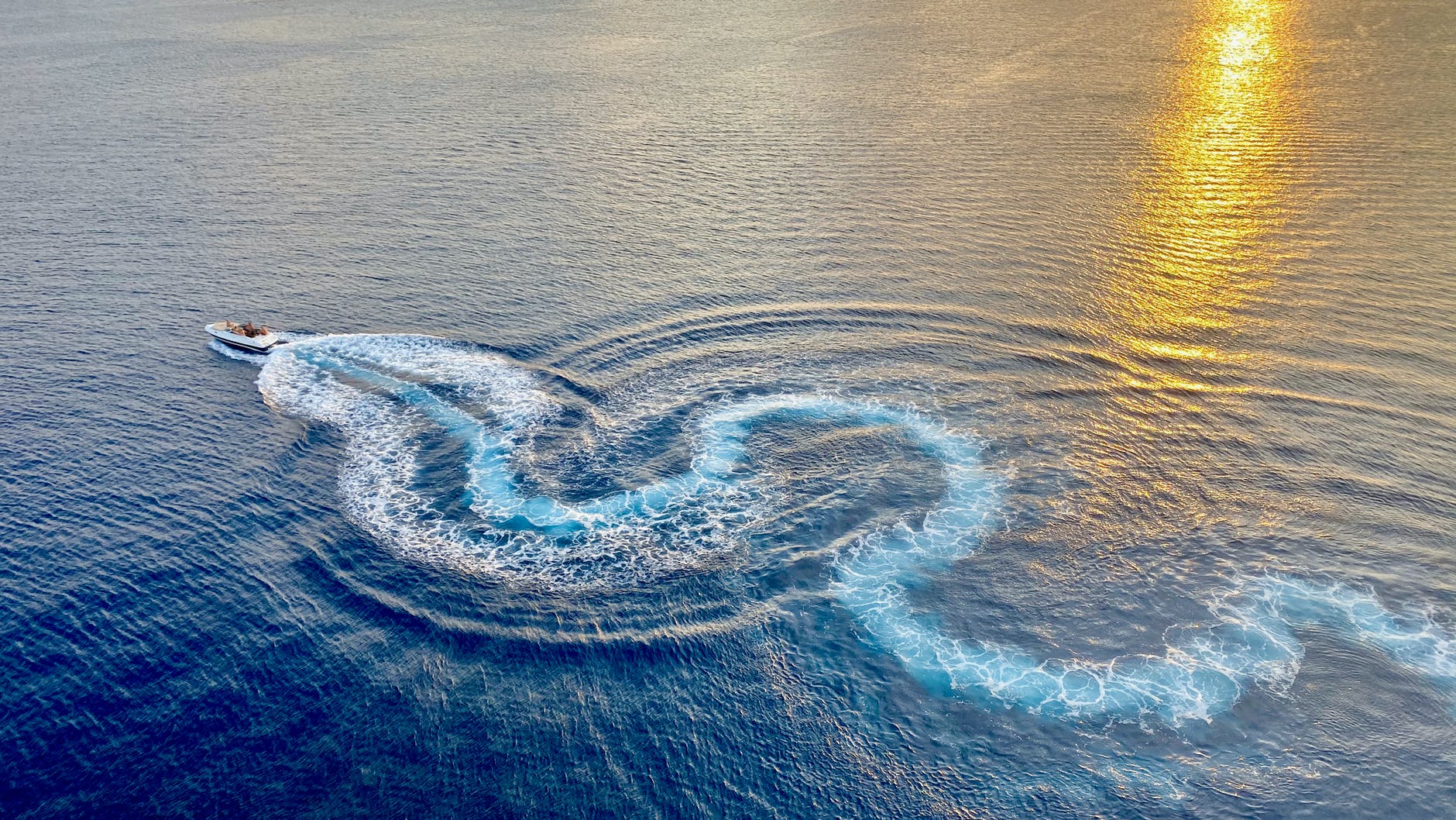 photo of speed boat on sea