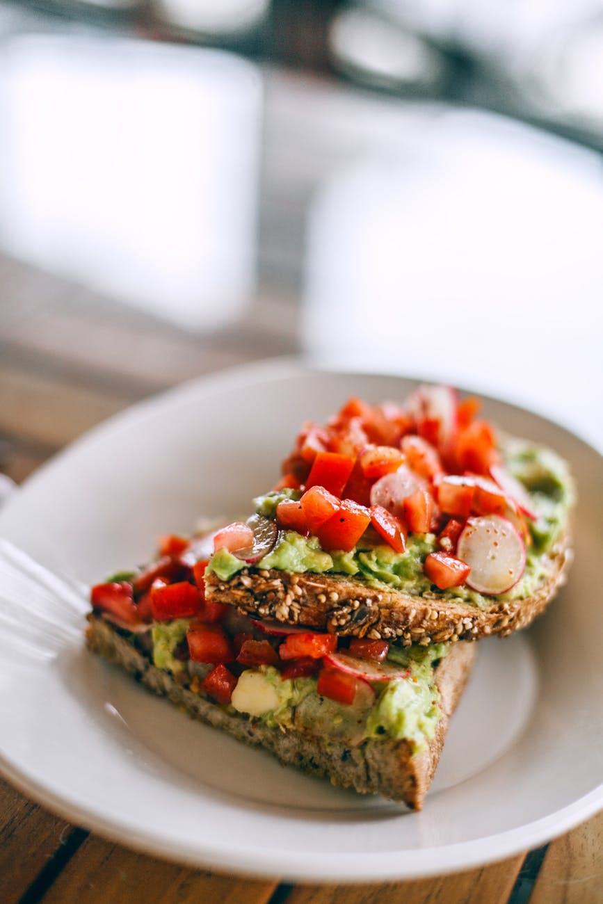 appetizing bruschettas with fresh vegetable slices on plate