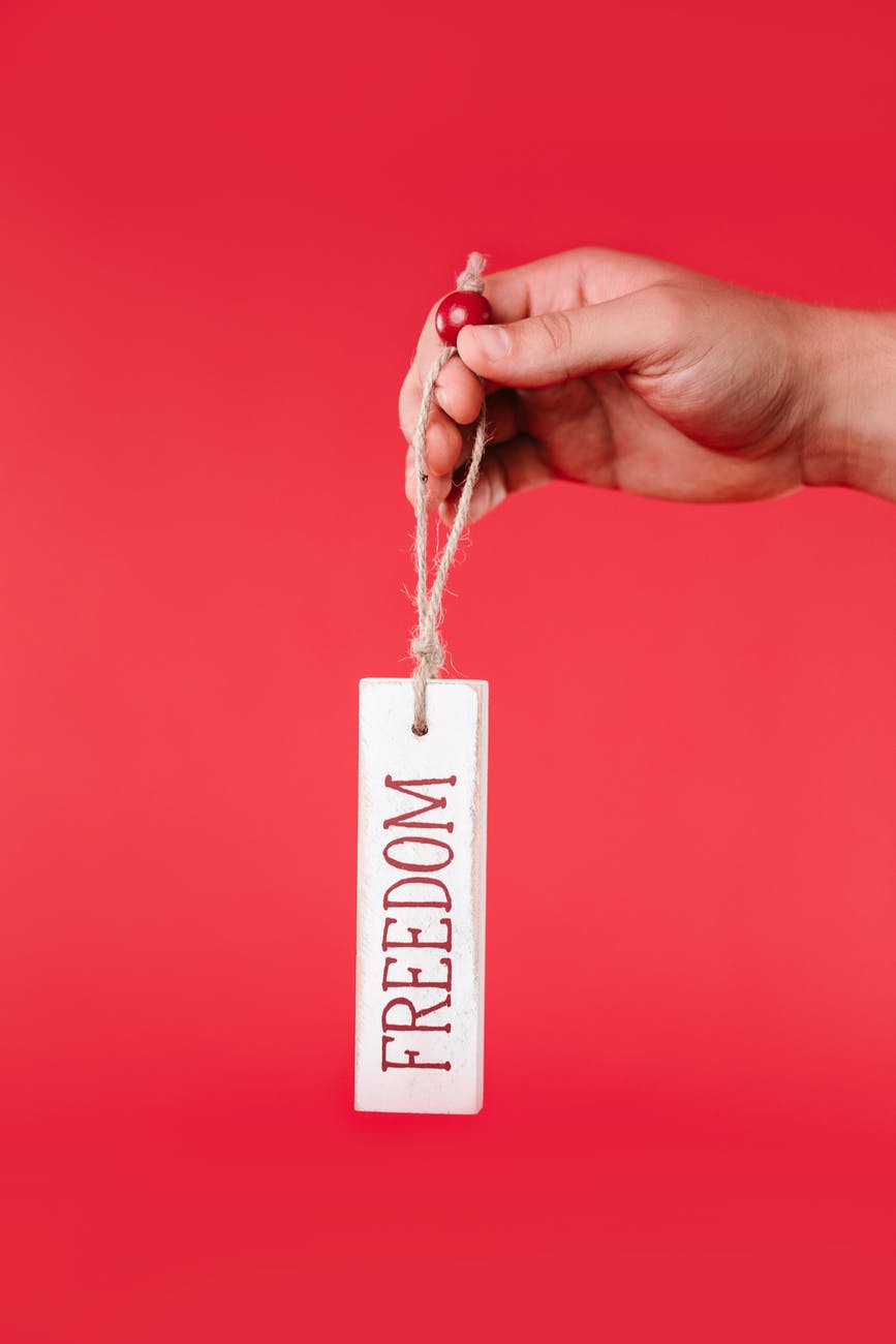 person holding a hang tag with print