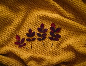 four brown leaves on textile