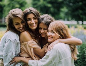 women hugging and smiling